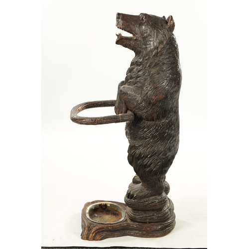 1040 - A LATE 19TH CENTURY CARVED BLACK FOREST BEAR STICK STAND Modelled as a standing bear with inset glas... 