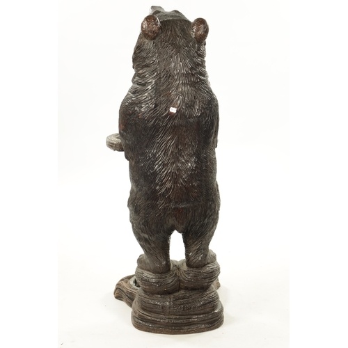 1040 - A LATE 19TH CENTURY CARVED BLACK FOREST BEAR STICK STAND Modelled as a standing bear with inset glas... 