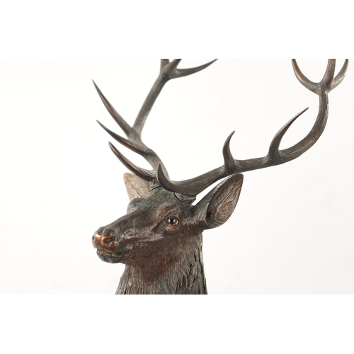 1041 - A FINE QUALITY LATE 19TH CENTURY BLACK FOREST CARVED STAG SIGNED ERNST HEISL with amber glass eyes s... 