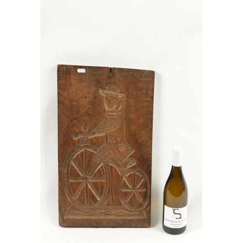 1044 - AN UNUSUAL 19TH CENTURY CARVED WOOD DOUBLE-SIDED GINGERBREAD MOULD depicting a figure riding a bicyc... 