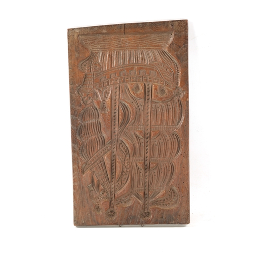 1044 - AN UNUSUAL 19TH CENTURY CARVED WOOD DOUBLE-SIDED GINGERBREAD MOULD depicting a figure riding a bicyc... 