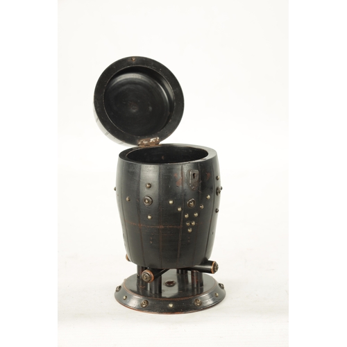 1047 - A 19TH CENTURY EBONISED CARVED WOOD TEA CADDY IN THE FORM OF A BARREL with applied stud work decorat... 