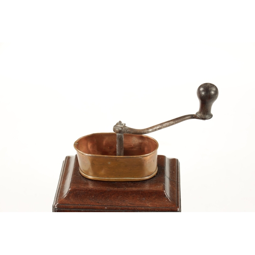 1055 - AN 18TH CENTURY MAHOGANY COFFEE GRINDER with ironwork handle and oval copper pan above a moulded edg... 