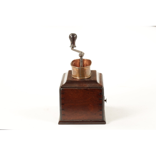 1055 - AN 18TH CENTURY MAHOGANY COFFEE GRINDER with ironwork handle and oval copper pan above a moulded edg... 