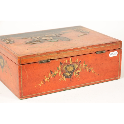 1056 - A 19TH CENTURY RED LACQUER AND CHINOISERIE DECORATED BOX with high relief figure and house decoratio... 