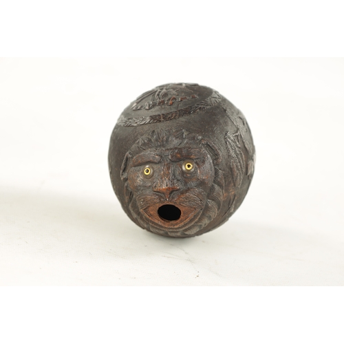 1058 - A FINE 18TH CENTURY CARVED COCONUT POWDER FLASK decorated with a hunting scene, having a flowerhead ... 