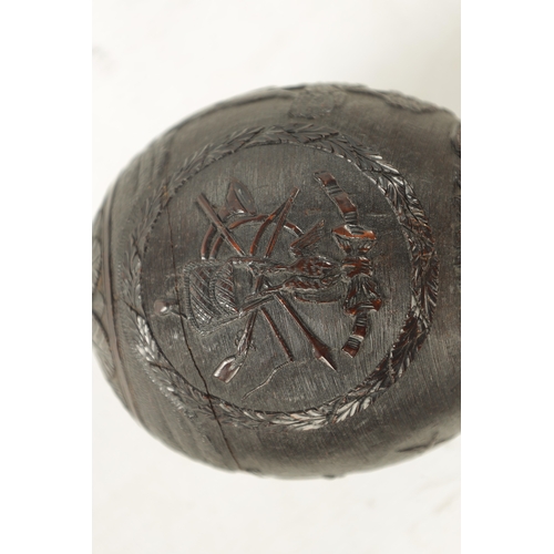 1058 - A FINE 18TH CENTURY CARVED COCONUT POWDER FLASK decorated with a hunting scene, having a flowerhead ... 