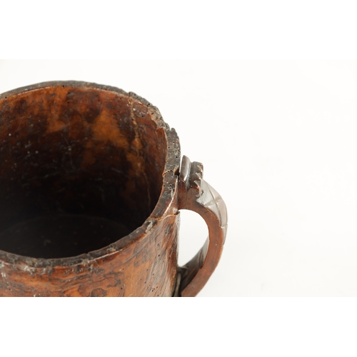 1059 - AN 18TH CENTURY SCANDINAVIAN BURR ELM AND IRON BOUND MUG with cross hatched shaped side handle. (13c... 