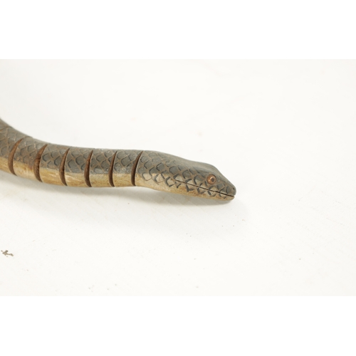 1060 - A LATE 19TH CENTURY ARTICULATED TOY SNAKE with painted scales and inset eyes, in pine box. (87cm lon... 