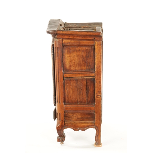 1061 - AN 18TH CENTURY FRUITWOOD MINIATURE ARMOIRE with panelled doors and frieze drawer to the base. (36.5... 