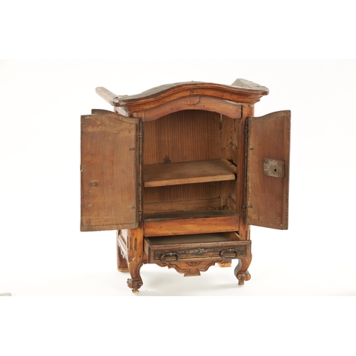 1061 - AN 18TH CENTURY FRUITWOOD MINIATURE ARMOIRE with panelled doors and frieze drawer to the base. (36.5... 