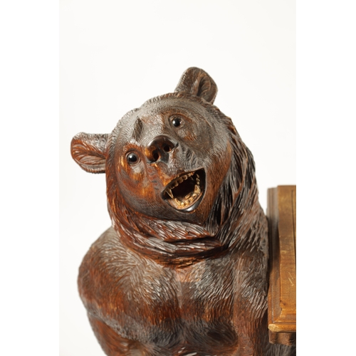 1068 - A GOOD 19TH CENTURY BLACK FOREST LINDEN WOOD CARVED BEAR HALL BENCH having two standing bear support... 