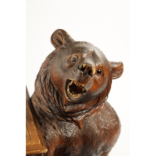 1068 - A GOOD 19TH CENTURY BLACK FOREST LINDEN WOOD CARVED BEAR HALL BENCH having two standing bear support... 