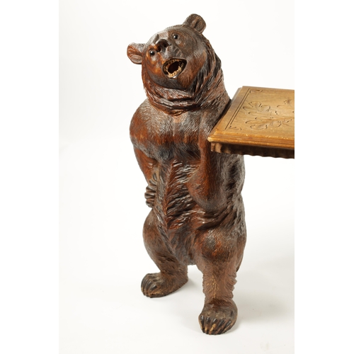 1068 - A GOOD 19TH CENTURY BLACK FOREST LINDEN WOOD CARVED BEAR HALL BENCH having two standing bear support... 