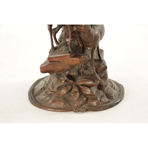 1072 - A LATE 19TH CENTURY CARVED BLACK FOREST EPERGNE CENTREPIECE modelled as two Chamois standing on a ro... 