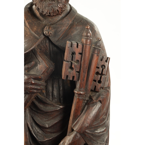 1075 - AN EARLY CARVED FIGURE OF ST. PETER standing holding keys and the bible (103cm high)