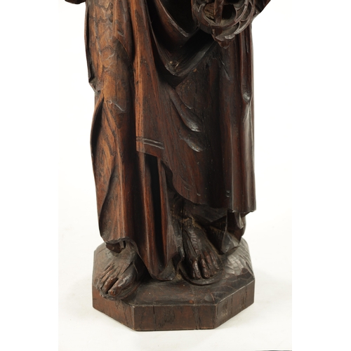 1075 - AN EARLY CARVED FIGURE OF ST. PETER standing holding keys and the bible (103cm high)