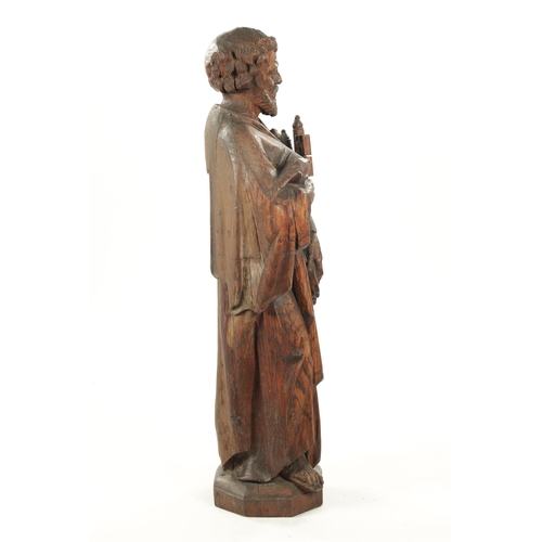 1075 - AN EARLY CARVED FIGURE OF ST. PETER standing holding keys and the bible (103cm high)