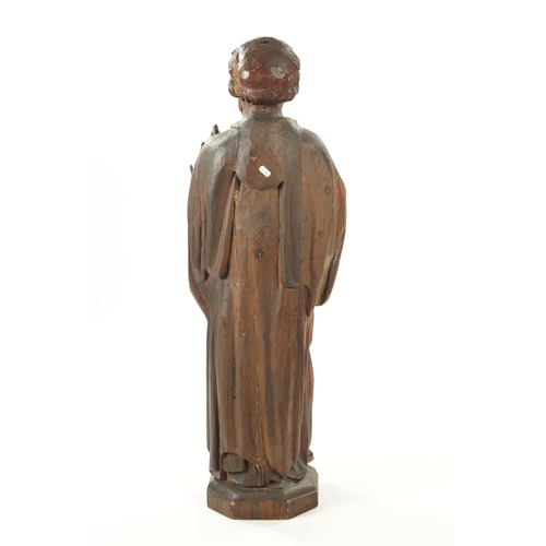 1075 - AN EARLY CARVED FIGURE OF ST. PETER standing holding keys and the bible (103cm high)