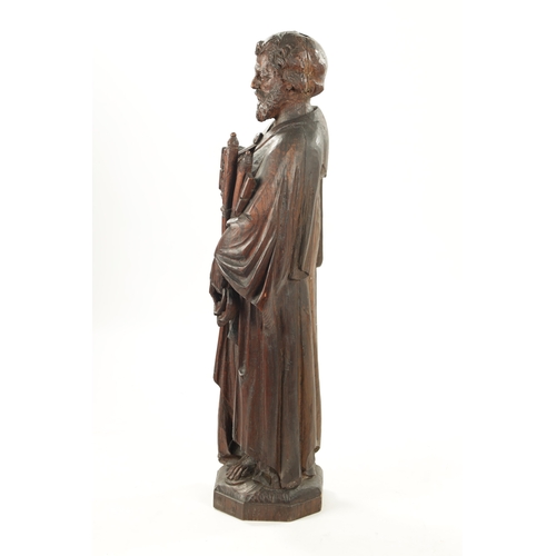 1075 - AN EARLY CARVED FIGURE OF ST. PETER standing holding keys and the bible (103cm high)