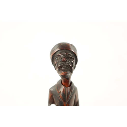 1086 - A 19TH CENTURY CONTINENTAL CARVED FRUITWOOD FIGURAL PIPE AND STAND with inset glass eye (one missing... 