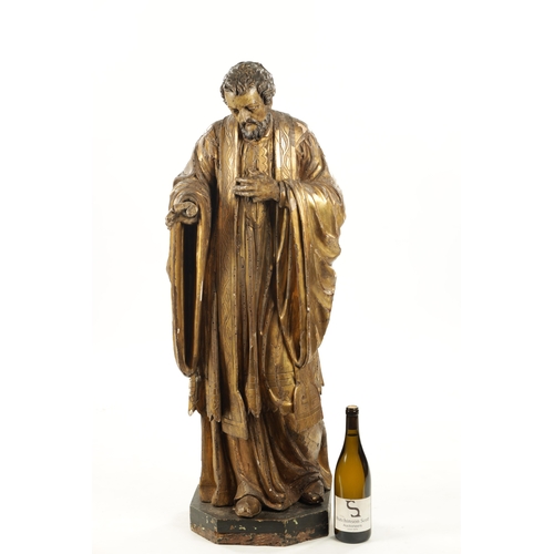 1087 - AN EARLY 17TH CENTURY CARVED WOOD GILT GESSO FIGURE OF CHRIST (104cm high)