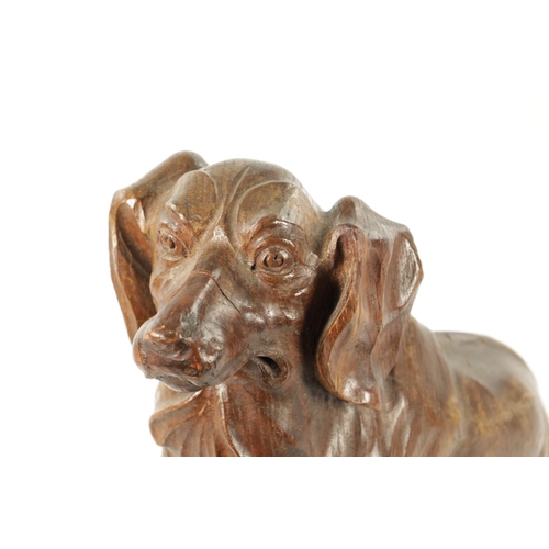 1089 - AN EARLY 20TH CENTURY ‘MOUSEMAN’ STYLE CARVED OAK SCULPTURE modelled as a seated dachund dog raised ... 