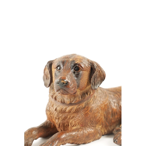 1090 - A 19TH CENTURY BLACK FOREST CARVED LINDEN WOOD DOG SCULPTURE set with glass eyes and depicted in an ... 