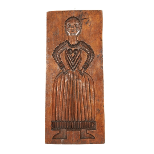 1094 - AN 18TH CENTURY ELM GINGER BREAD MOULD modelled as a lady in dress (56.5cm high 25.5cm wide)