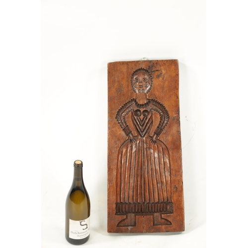 1094 - AN 18TH CENTURY ELM GINGER BREAD MOULD modelled as a lady in dress (56.5cm high 25.5cm wide)