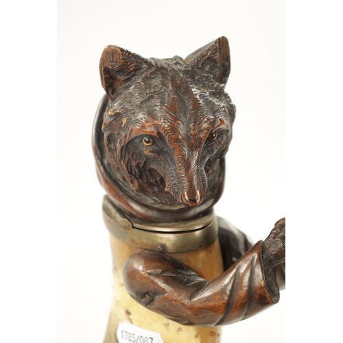 1096 - A 19TH CENTURY BLACK FORREST CARVED WOOD AND HORN INKWELL formed as a standing hooded fox with hinge... 