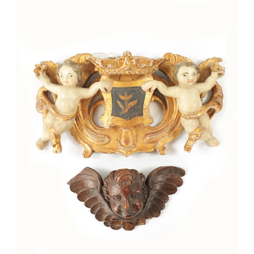 1097 - A 17TH CENTURY OAK WINGED ANGELS HEAD CARVING together with a Carved giltwood and painted DOUBLE CHE... 