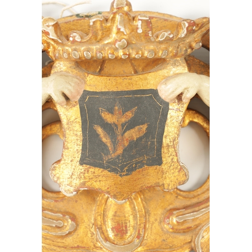 1097 - A 17TH CENTURY OAK WINGED ANGELS HEAD CARVING together with a Carved giltwood and painted DOUBLE CHE... 