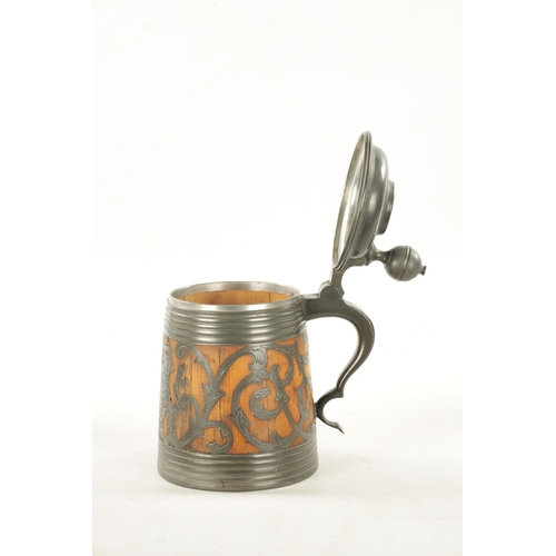 1101 - A 19TH CENTURY SWEDISH COMMEMORATIVE OAK AND PEWTER TANKARD inlaid scrollwork decoration and royal c... 