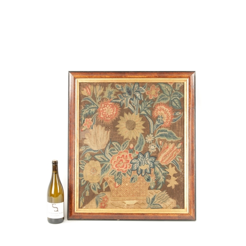 1155 - AN 18TH CENTURY FRAMED NEEDLEWORK PICTURE depicting a colourful flower basket on a shelf. Moulded wa... 