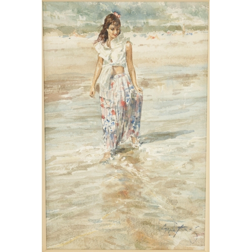 1192 - GORDON KING (b. 1939) WATERCOLOUR. Girl wading in the sea signed lower right - mounted in a glazed l... 