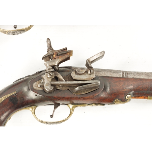 798 - A PAIR OF 18TH CENTURY BRASS MOUNTED SPANISH FLINTLOCK PISTOLS each fitted a two-stage steel barrel ... 