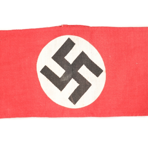 817 - A COLLECTION OF GERMAN WWII THIRD REICH ITEMS comprising of two arm bands and two enamel badges. (4)