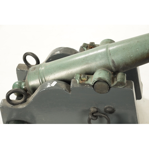 820 - A 19TH CENTURY GREEN PATINATED SIGNALLING CANON on shaped painted wooden base (canon is 80cm overall... 