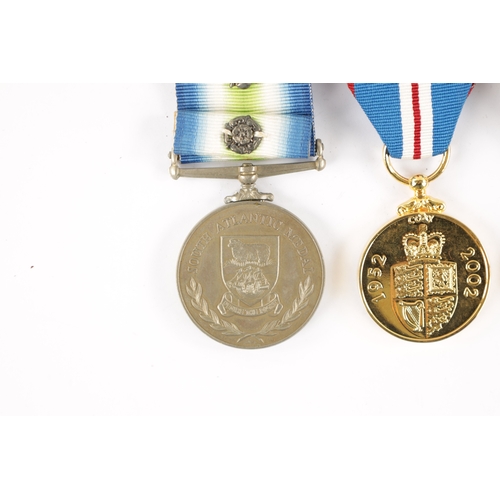 878 - A 1982 FALKLANDS WAR SOUTH ATLANTIC MEDAL WITH ROSETTE. Presented to OM F. KENNY. RFA. OLMEDA, toget... 