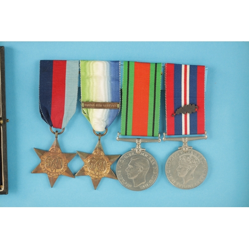 907 - A GROUP OF FIVE WW2 MEDALS in glazed case. Comprising of a Distinguished Service Cross in its origin... 