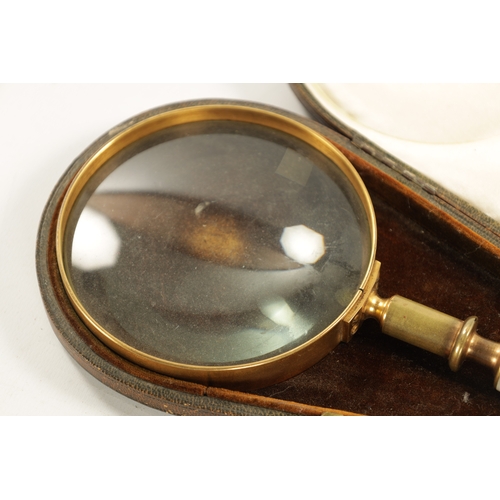 916 - A LATE 19TH CENTURY CASED MAGNIFYING GLASS with a tooled Moroccan leather case, the glass with brass... 