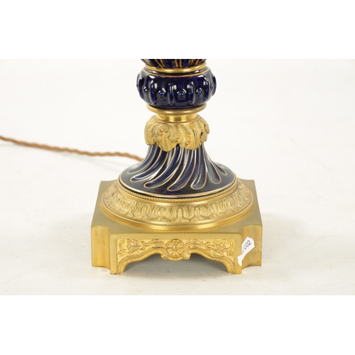 920 - A LATE 19TH CENTURY ORMOLU AND SEVRES PORCELAIN VASE CONVERTED TO A LAMP with gadrooned cobalt blue ... 