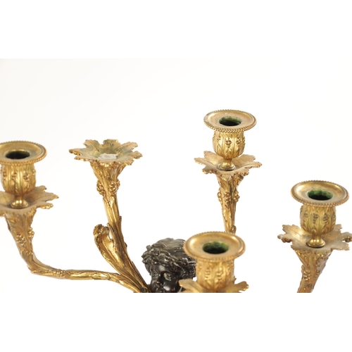 923 - A GOOD PAIR OF ORMOLU AND BRONZE CHERUB FIVE BRANCH CANDELABRA raised on circular rouge marble bases... 