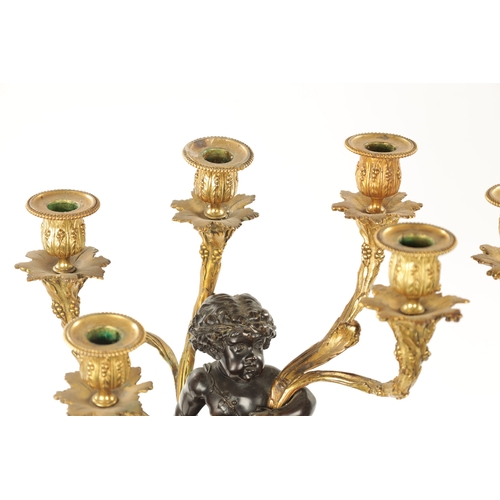 923 - A GOOD PAIR OF ORMOLU AND BRONZE CHERUB FIVE BRANCH CANDELABRA raised on circular rouge marble bases... 