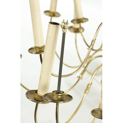 925 - A LARGE 20TH CENTURY BRASS HANGING LIGHT with shaped arms holding eighteen candle lights, with bulbo... 