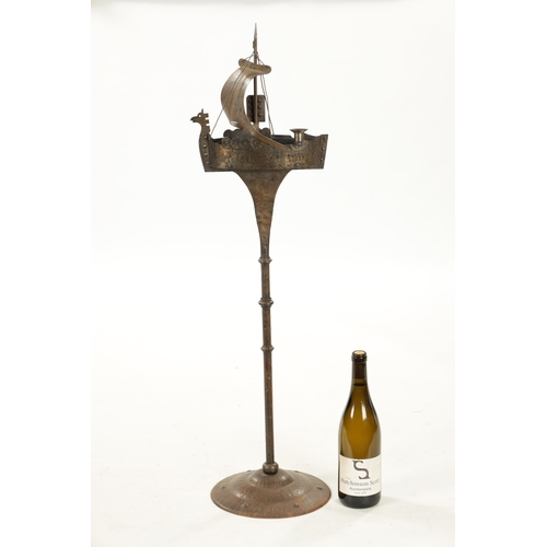 934 - AN ARTS AND CRAFTS NOVELTY STEELWORK STANDING ASHTRAY formed as a galleon (90cm high )