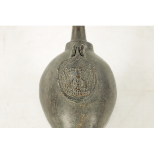 939 - AN 18TH CENTURY PEWTER WHALING LAMP with mask head lid and pierced back. (28cm wide )