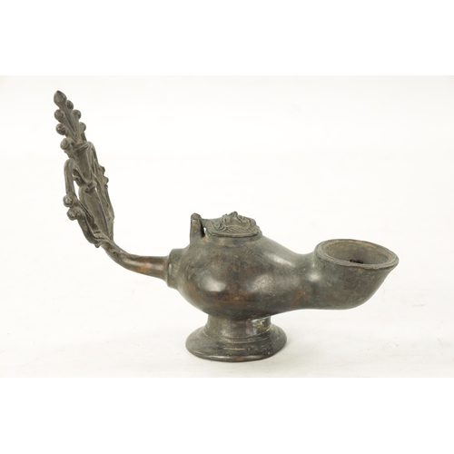 939 - AN 18TH CENTURY PEWTER WHALING LAMP with mask head lid and pierced back. (28cm wide )