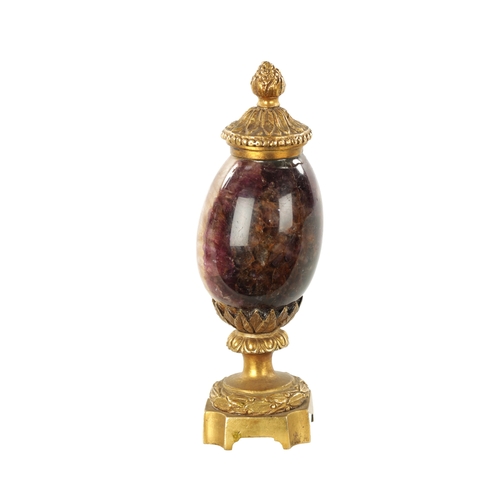 942 - A 19TH CENTURY ORMOLU MOUNTED BLUE JOHN URN with leaf cast finial and matching base. (15cm high)